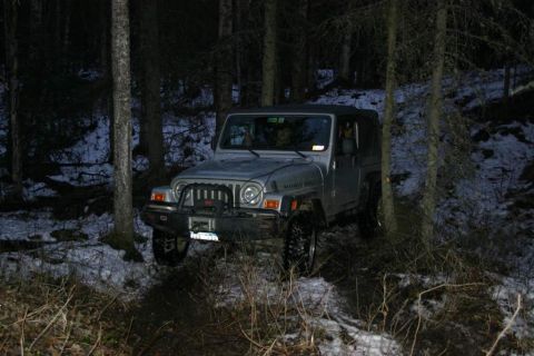 2003 Jeep TJ - A silver 2003 Jeep TJ is parked on a snowy forest trail at night.