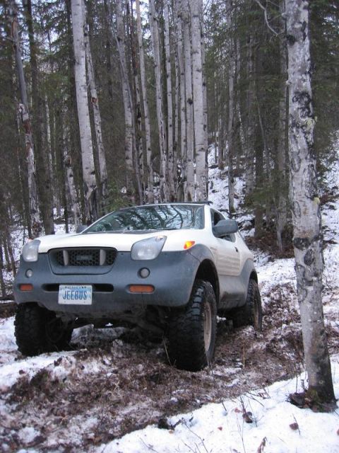 1993 Ford Bronco - Isuzu VehiCROSS navigating a snowy trail with large off-road tires.