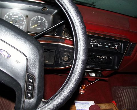 1988 Ford C-350 (Centurion Conversions) - Interior view of a vehicle's dashboard, showing the steering wheel, instrument cluster, and center console with radio.