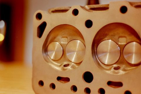 1976 Toyota Land Cruiser - Close-up of an engine cylinder head, revealing its internal combustion chambers and valves.