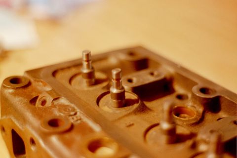 1976 Toyota Land Cruiser - Close-up view of an engine cylinder head, showing valve stems protruding from their seats.
