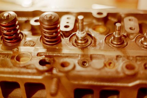 1976 Toyota Land Cruiser - A close-up view of an engine's cylinder head, showing valve springs and stems.