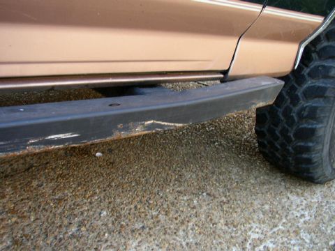 1995 Ford Bronco - Close-up of a vehicle's side, highlighting the running board and a portion of the tire.