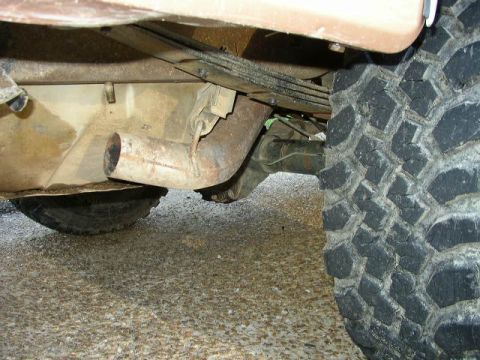 1995 Ford Bronco - Undercarriage view showing the rear axle, exhaust, and tire of a vehicle.