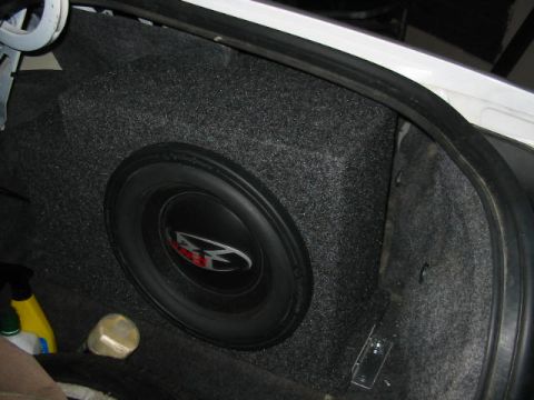 1997 Ford Crown Victoria - Subwoofer installed in a car's trunk, with cleaning supplies nearby.