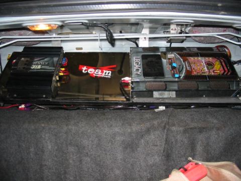 1997 Ford Crown Victoria - Two car audio amplifiers are installed in the trunk of a vehicle.