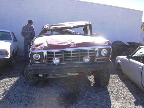 1978 Ford Bronco - This 1978 Ford Bronco shows significant damage to its roof and hood, with MSD decals visible on the grille.