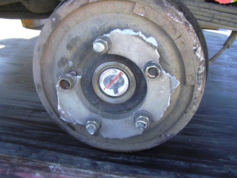 1978 Ford Bronco - Close-up of a wheel hub assembly a "Dutchembodies" sticker and visible lug nuts, indicating a vehicle part.