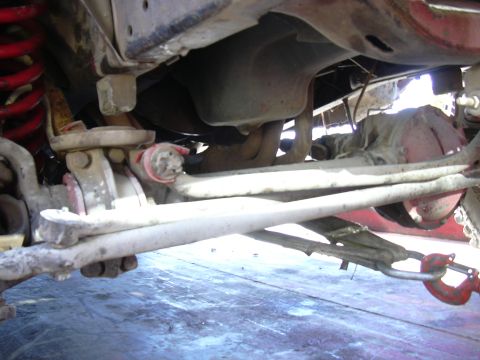 1978 Ford Bronco - Close-up of a vehicle's undercarriage, focusing on suspension and drivetrain components.
