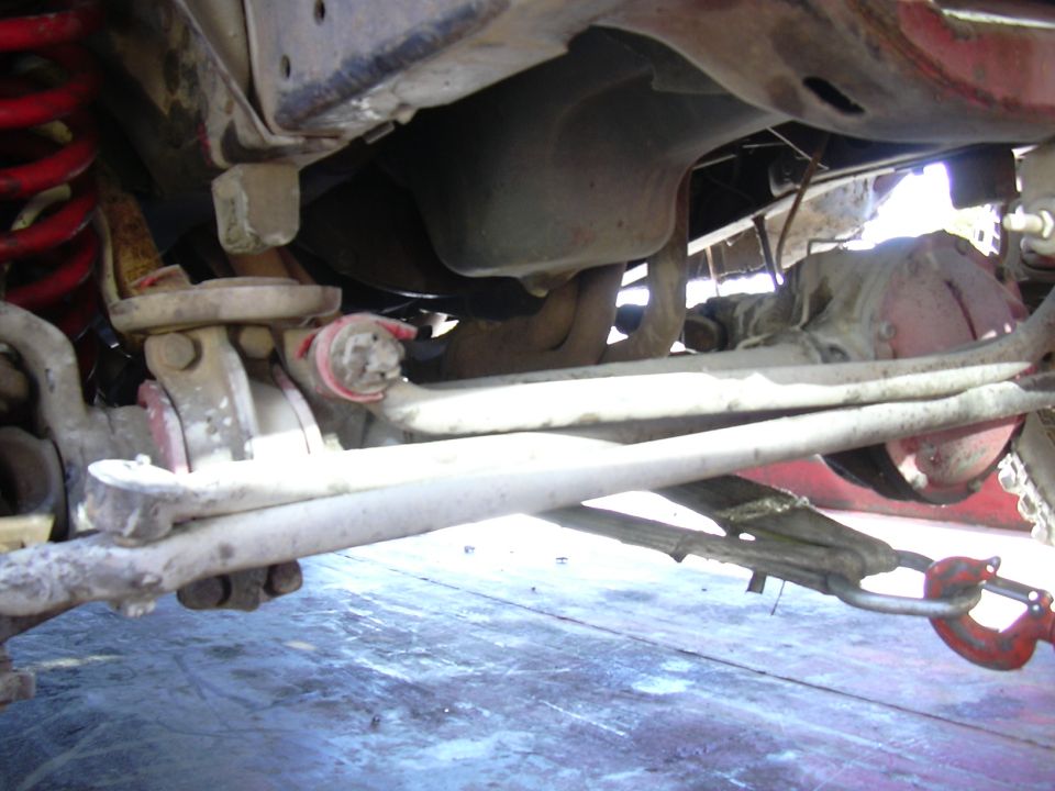 Undercarriage view showing suspension, differential, and a tow hook attached to the frame