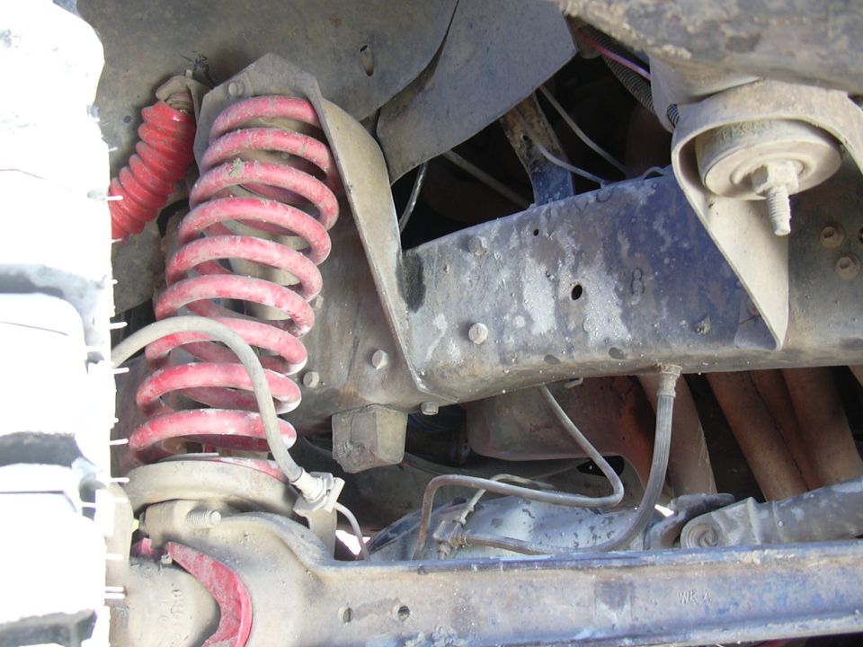 1978 Ford Bronco undercarriage with red coil springs and shock absorbers