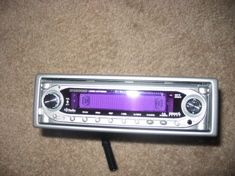 1988 Ford Bronco - A silver car stereo with a purple display and various buttons is shown.