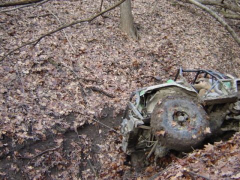 1992 Ford Bronco - Off-road buggy with roll cage stuck in a muddy ditch covered in leaves.
