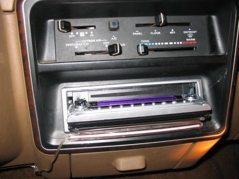 1988 Ford Bronco - Dashboard interior showing car stereo and climate controls with various slider and knob adjustments.