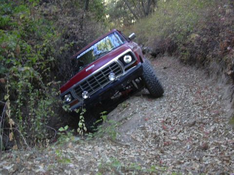 1978 Ford Bronco - 1978 Ford Bronco tackling a challenging off-road path.