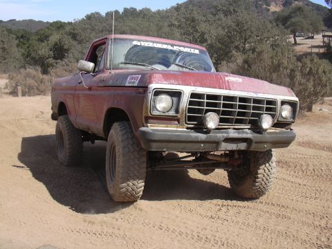1978 Ford Bronco - This red pickup truck appears to be a 1978 model, based on its grille design.