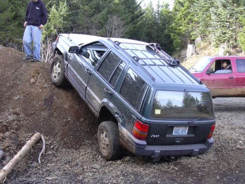 1991 Ford Bronco - A Jeep Grand Cherokee navigates a steep, rocky incline with another vehicle waiting nearby.