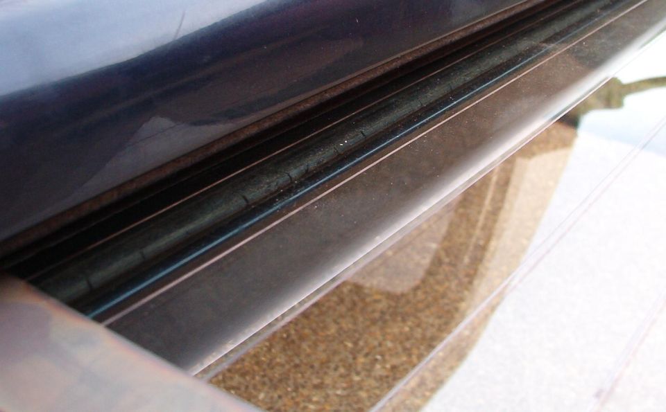 This outer weatherbelt has begun to dry rot, and is already leaking water into the unpainted interior of the tailgate.  The dirt it brings with it will cause the bottom of the tailgate to rust out from the inside.  If the inner one gets this bad, it will scratch the heating element which could cause a hot spot that would shatter the glass.
