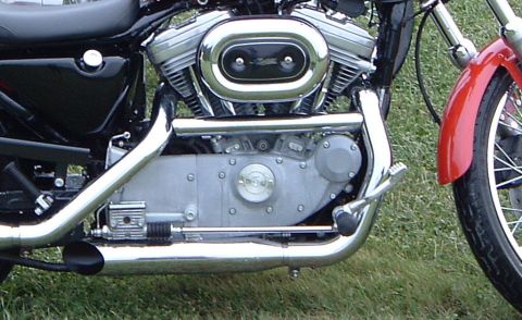 1995 Mercury Grand Marquis - Close-up view of a motorcycle's engine and exhaust system, with a red fender visible on the right.