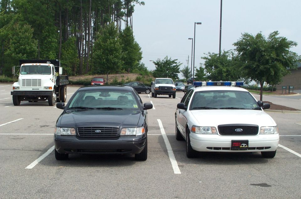 Tiny thumbnail of two vehicles facing each other in a lot
