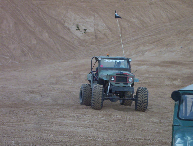 Tiny thumbnail of an off-road buggy kicking up sand on a dune