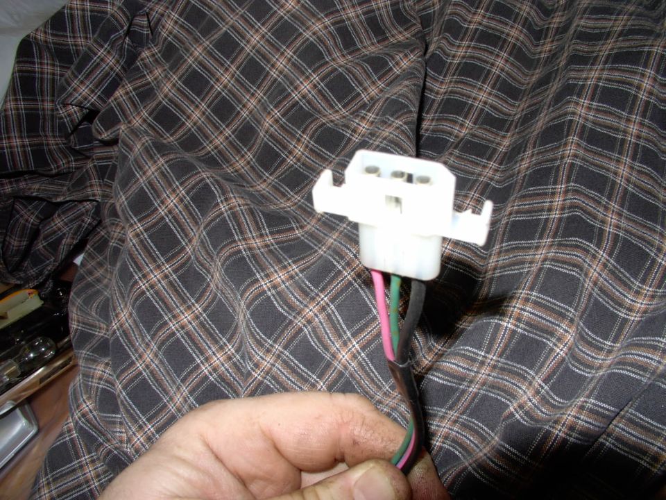 The female 3 pin plug I wired into the stock harness utilizing the no longer used rear speaker wires. They're already there and run across under the rug anyway and they go to within inches of the former ashtrays on both sides.  The stock 4 wire speaker harness plug is re-routed at the driver's kick panel.