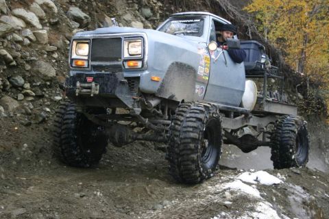 2003 Jeep TJ - This heavily modified Dodge Ram pickup truck is shown navigating a challenging off-road trail.