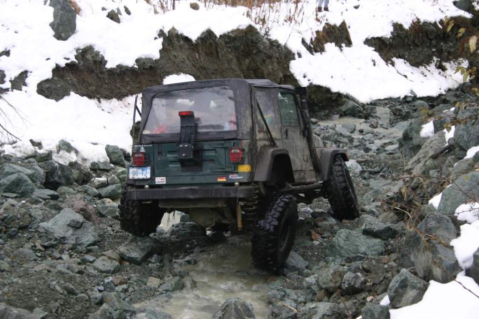 2003 Jeep TJ rear view, driving over rocks in snow