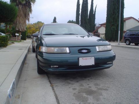 1993 Ford Taurus - Front view of a 1993 Ford Taurus parked curbside on a residential street.