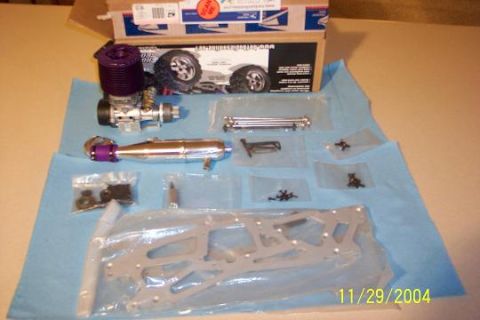 1996 Mercury Sable - Various components for an RC car are displayed, including an engine, exhaust pipe, and chassis parts.