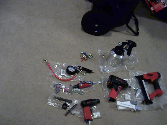 Collection of air tools including a spray gun, impact wrench, nail gun, and tire inflator