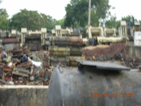 1984 Chevrolet Blazer - A yard filled with discarded metal and equipment, dated 2004.
