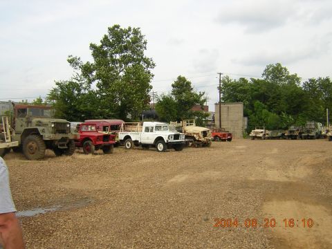 1984 Chevrolet Blazer - A collection of trucks and SUVs are parked in an outdoor lot under a cloudy sky.
