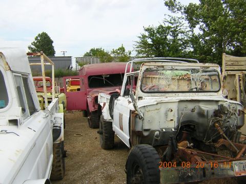 1984 Chevrolet Blazer - A collection of vintage trucks and SUVs are lined up in an outdoor lot, showing signs of age and disrepair.