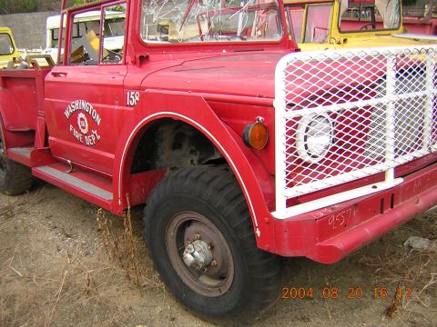 1984 Chevrolet Blazer - A weathered red fire truck with a white grille guard sits in a yard with other vehicles.