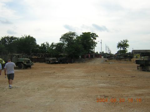1984 Chevrolet Blazer - A collection of military vehicles are visible in an outdoor storage yard.