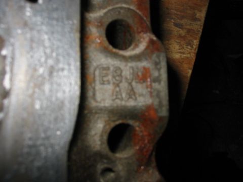 1985 Ford LTD Crown Victoria - A close-up view of a metal engine component shows stamped identification marks.