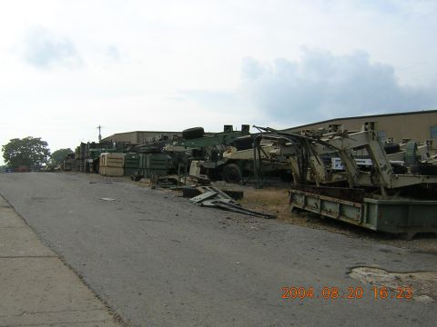1984 Chevrolet Blazer - A collection of various military vehicles and equipment are stored in an outdoor lot.