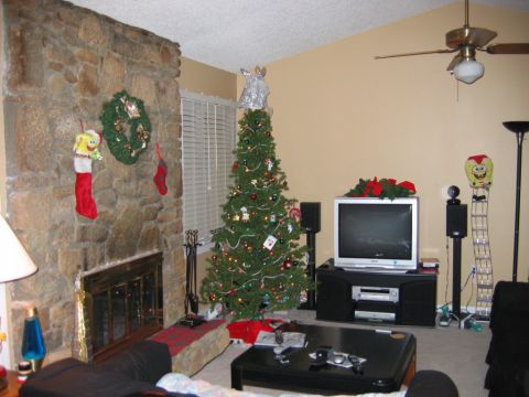 1985 Ford LTD Crown Victoria - A living room scene decorated for Christmas, a lit tree and stockings by the fireplace.