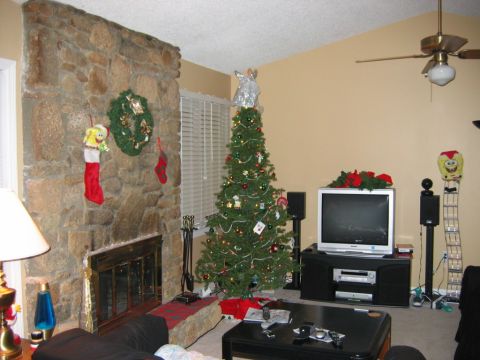 1985 Ford LTD Crown Victoria - A living room is decorated for Christmas with a tree, stockings, and a wreath.