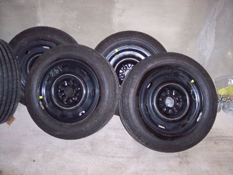 2001 Ford Crown Victoria - A collection of four spare tires, likely for a sedan or similar vehicle, are shown with their steel wheels.