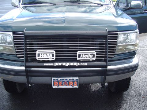 1990 Ford Bronco - This truck features a prominent grille guard with auxiliary lighting and a Chicago Bears themed license plate.