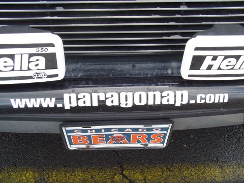 1990 Ford Bronco - A close-up view of a vehicle's front bumper shows a Chicago Bears license plate and various stickers.