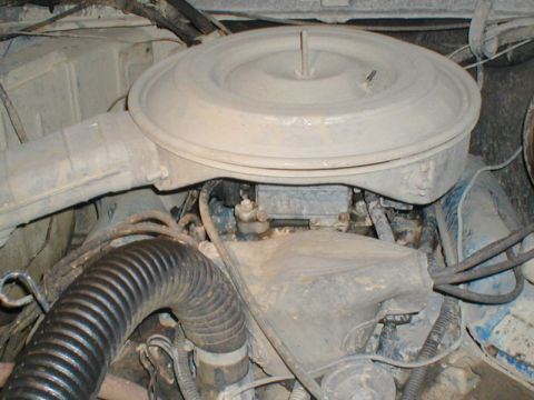 1979 Ford Bronco - Close-up view of a dusty engine bay, focusing on the air intake system.