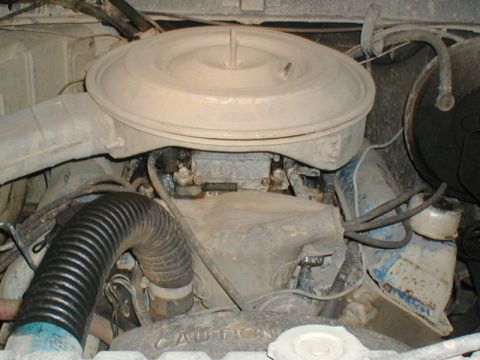 1979 Ford Bronco - Close-up view of a dusty engine bay, showing the air filter housing and carburetor.