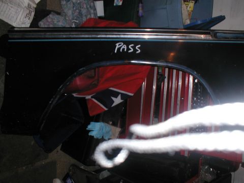 1979 Ford Bronco - A black fender with blue trim and the word "PASS" written in white marker is visible.
