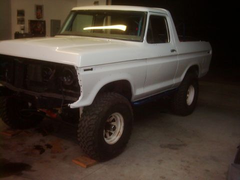 1978 Ford Bronco - This white 1978 Ford Bronco is shown with its front end disassembled, highlighting its lifted suspension.