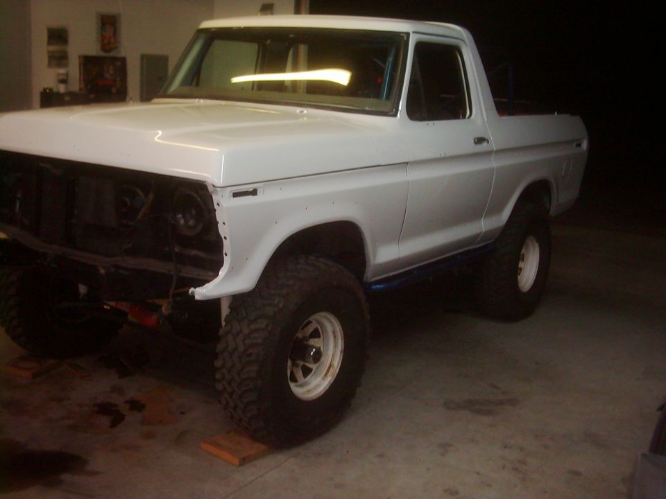 White 1978 Ford Bronco, front end removed, lifted