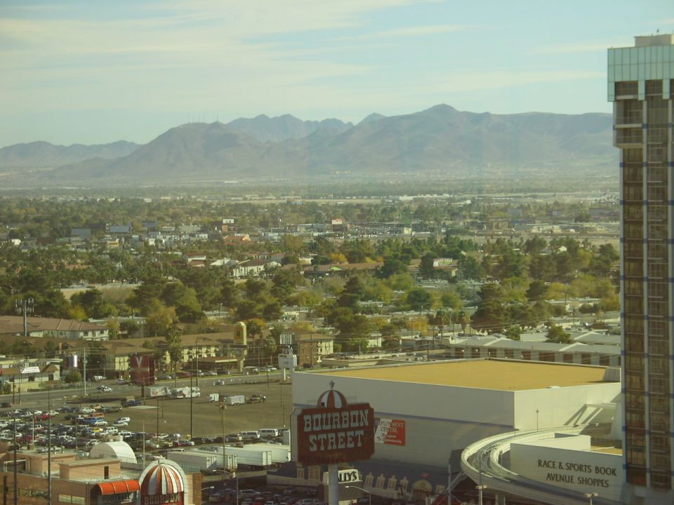 Las Vegas cityscape with mountains and a large parking lot
