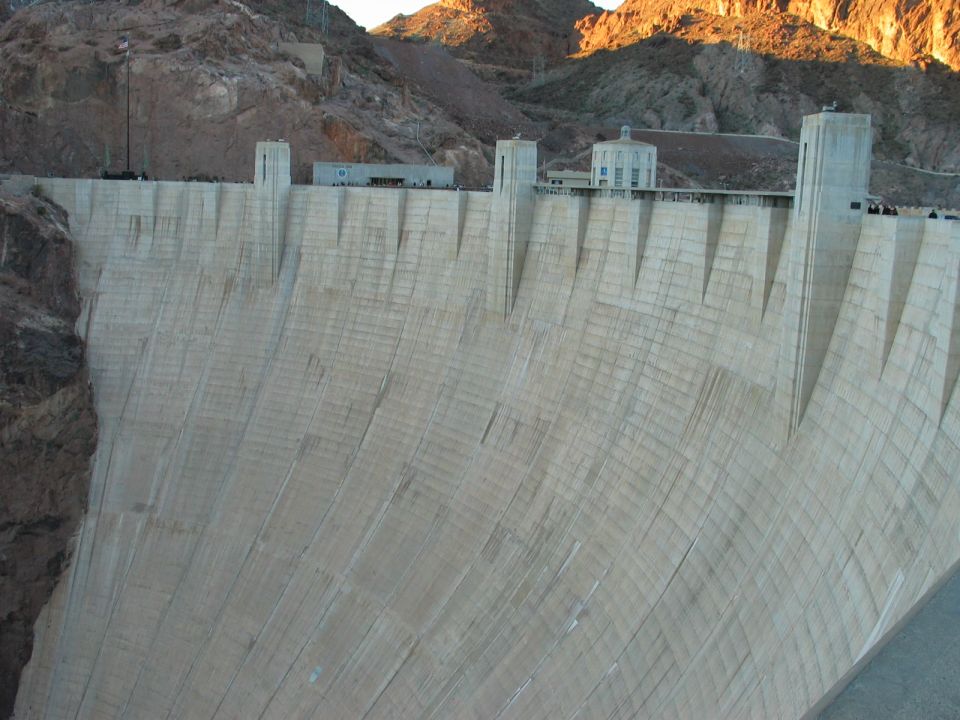 Hoover Dam concrete structure with mountains in background and Supermotors.net logo